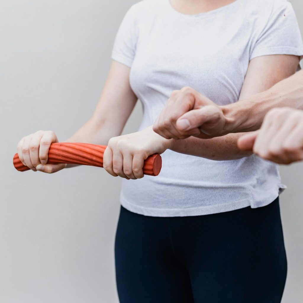 a woman holding a red handle while standing next to a man